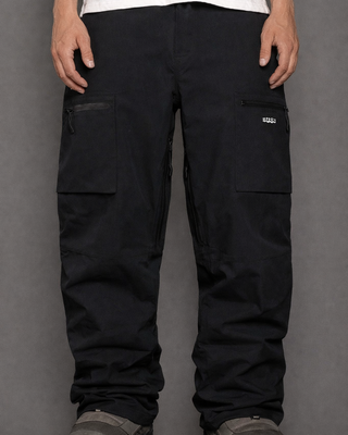 Black cargo pants worn by a person on a gray background