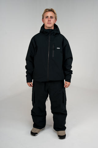 BUSI Biggie Cargo Pant Black snowboard and ski cargo pants, full outfit with Core Jacket on model