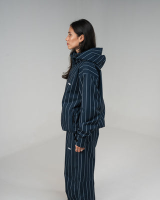 BUSI Core Jacket Pinstripe snowboard and ski jacket, side view on female model
